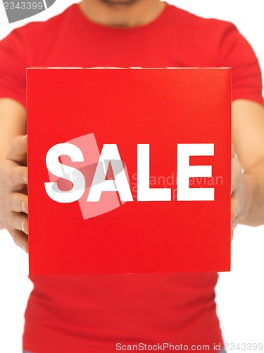 Image of man holding sale sign