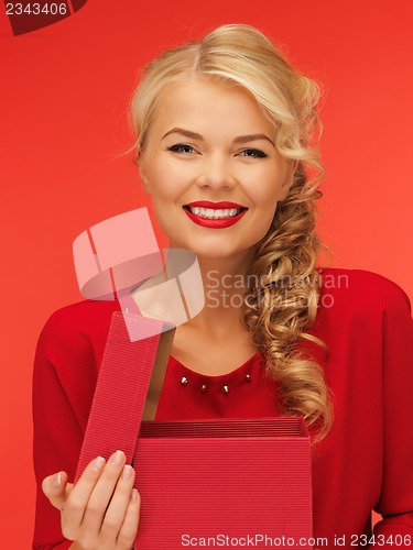 Image of lovely woman in red dress with opened gift box