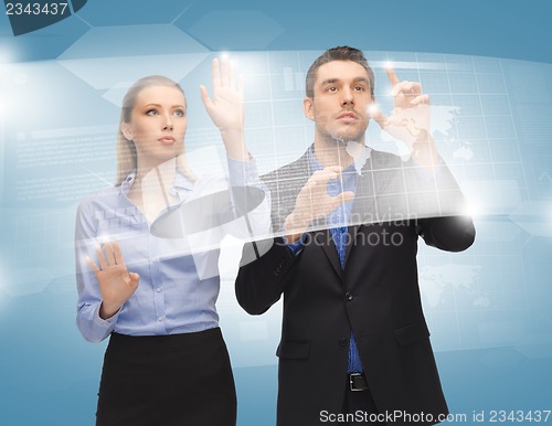 Image of man and woman working with virtual touch screens