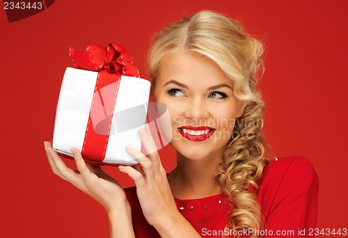 Image of lovely woman in red dress with present