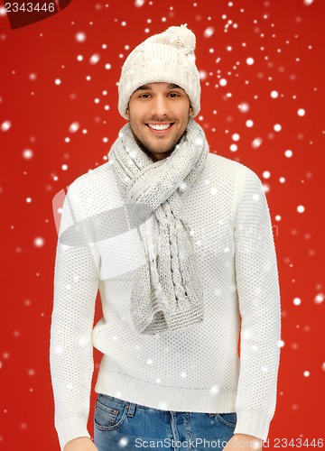 Image of handsome man in warm sweater, hat and scarf