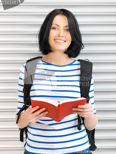 Image of woman with bag and book