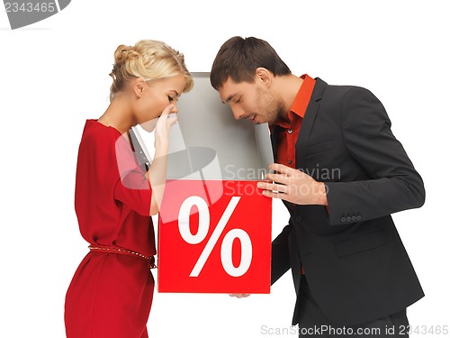Image of man and woman with percent sign