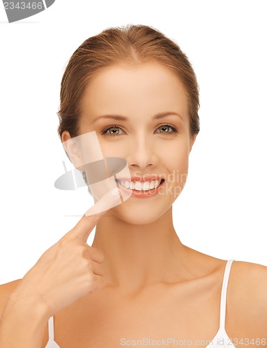 Image of beautiful woman pointing to teeth