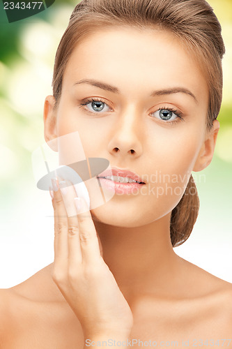 Image of beautiful woman with cotton pad