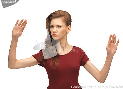 Image of girl in red dress working with something imaginary