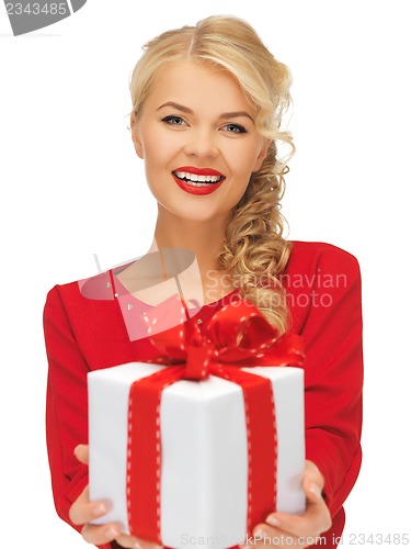 Image of lovely woman in red dress with present