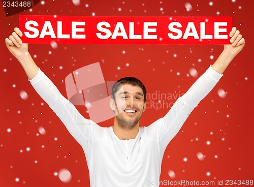 Image of handsome man with sale sign