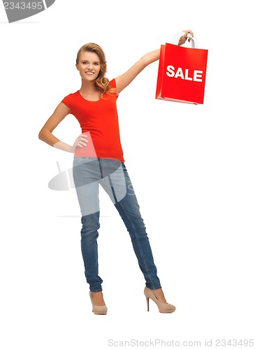 Image of teenage girl in red t-shirt with shopping bag