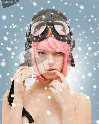 Image of pink hair girl in aviator helmet with snow