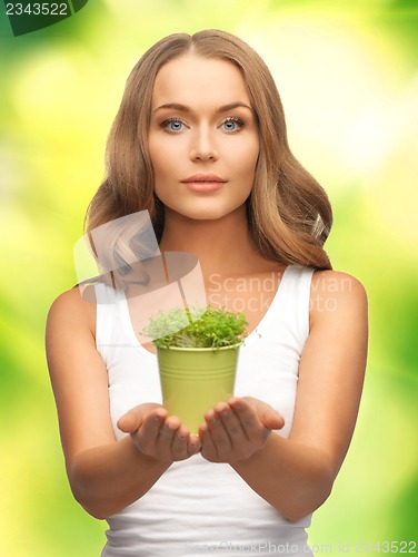 Image of woman with green grass in pot