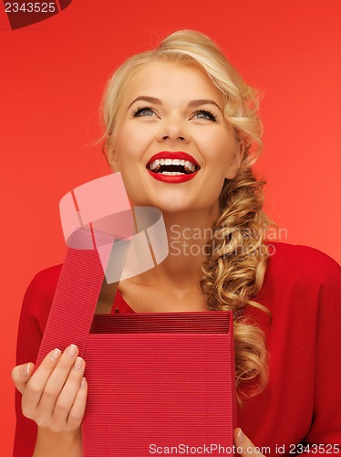 Image of lovely woman in red dress with opened gift box