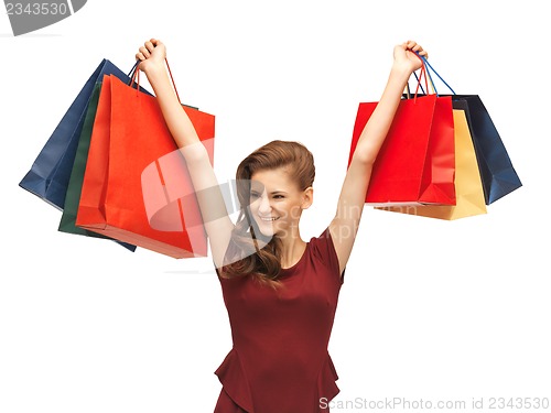 Image of teenage girl in red dress with shopping bags