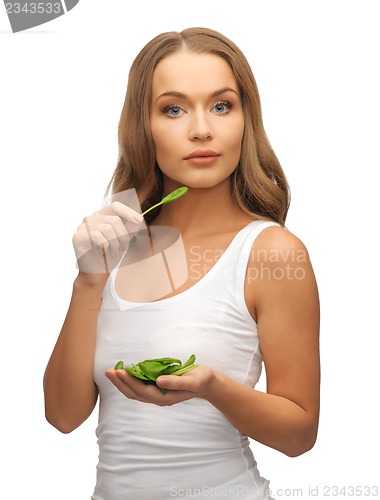 Image of woman with spinach leaves on palms