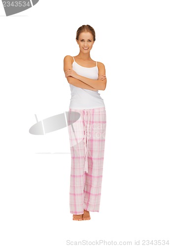 Image of happy and smiling woman in cotton pajamas