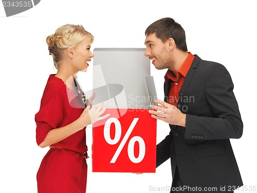 Image of man and woman with percent sign