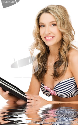 Image of woman in bikini with tablet pc computer