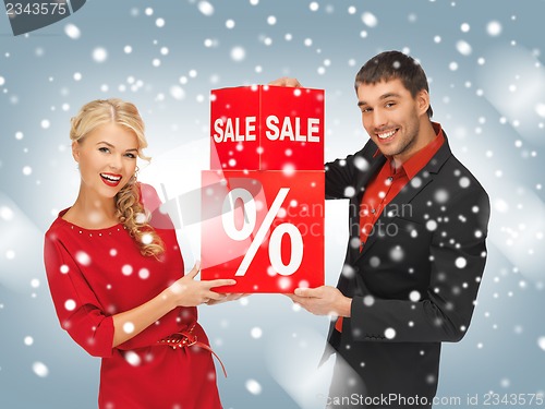 Image of man and woman with percent sign