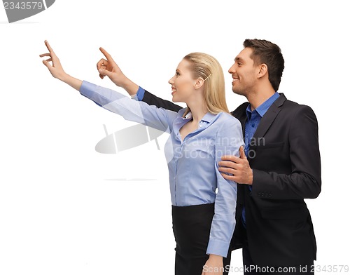 Image of man and woman working with something imaginary