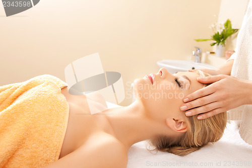 Image of beautiful woman in massage salon