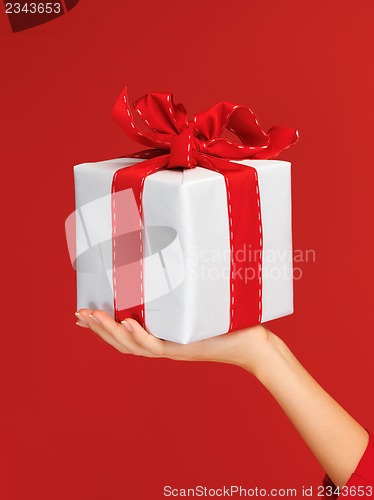 Image of woman's hands holding a gift box