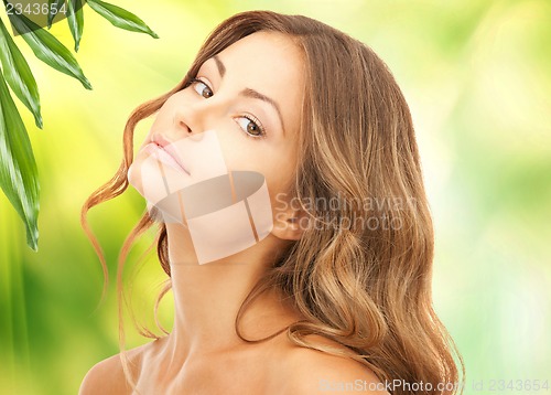 Image of beautiful woman with green leaves