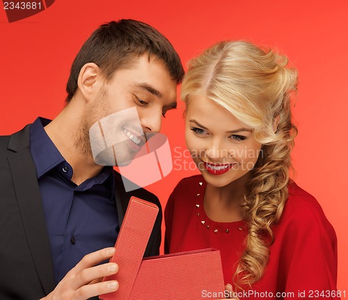 Image of man and woman looking inside the gift box