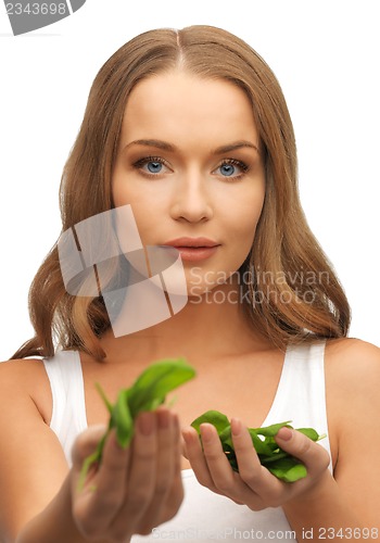 Image of woman with spinach leaves on palms