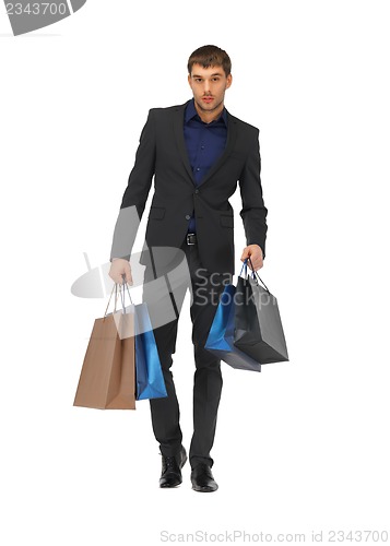 Image of handsome man in suit with shopping bags