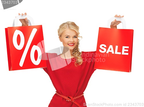 Image of beautiful woman in red dress with shopping bag