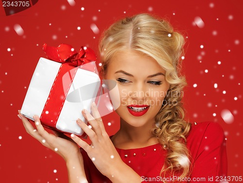 Image of lovely woman in red dress with present