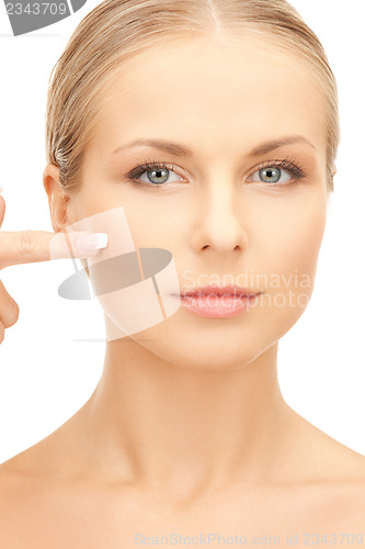 Image of beautiful woman pointing to cheek