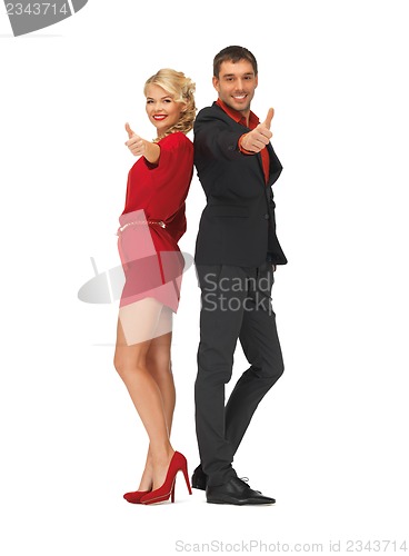 Image of handsome man and lovely woman showing thumbs up