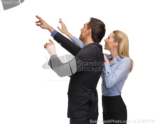 Image of man and woman working with something imaginary