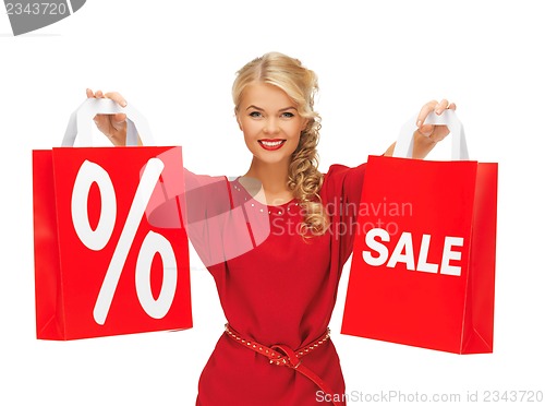 Image of beautiful woman in red dress with shopping bag