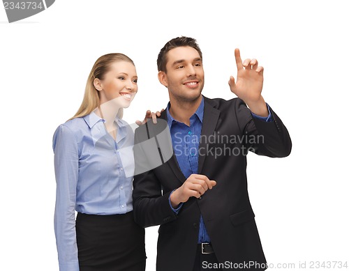 Image of man and woman working with something imaginary