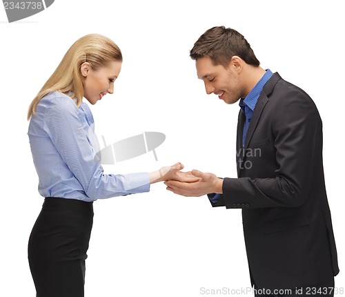 Image of man and woman showing something on the palms