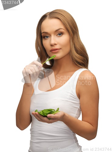 Image of woman with spinach leaves on palms