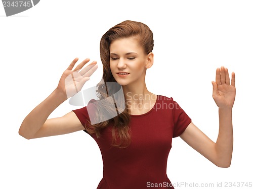 Image of girl in red dress working with something imaginary