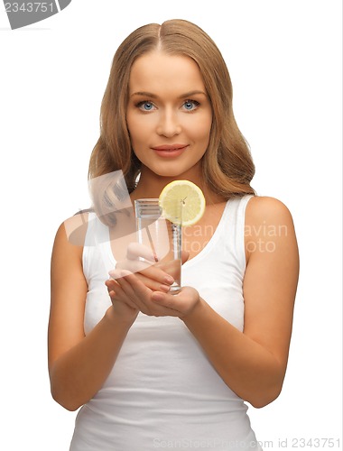 Image of woman with lemon slice on glass of water