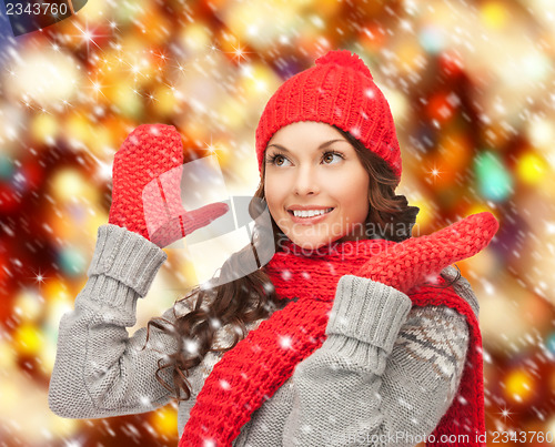 Image of beautiful woman in hat, muffler and mittens