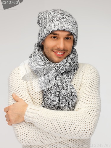 Image of handsome man in warm sweater, hat and scarf