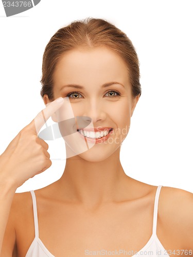 Image of beautiful woman pointing to eye