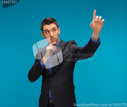 Image of man in suit working with something imaginary