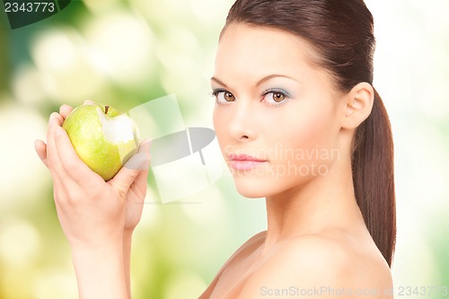 Image of young beautiful woman with green apple