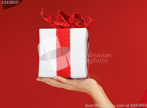 Image of woman's hands holding a gift box