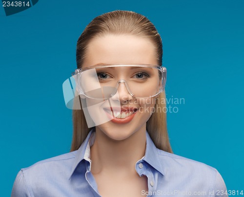 Image of businesswoman in protective glasses