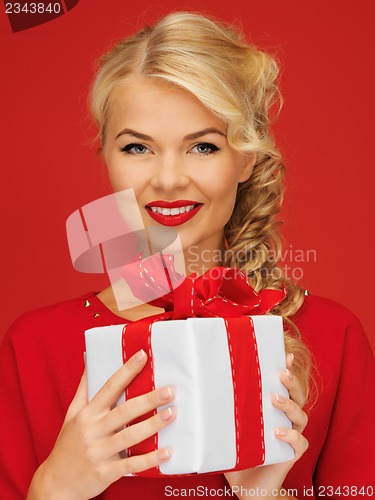 Image of lovely woman in red dress with present