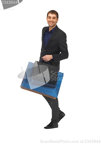 Image of handsome man in suit with shopping bags