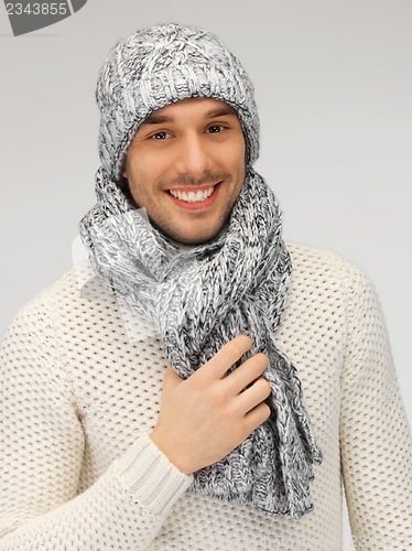 Image of handsome man in warm sweater, hat and scarf